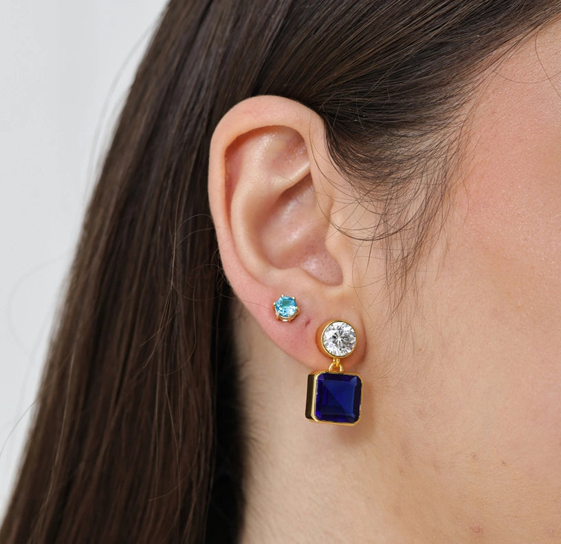 Deep blue sapphire and sparkling zirconia earrings with a sleek gold drop design and secure push-back closure