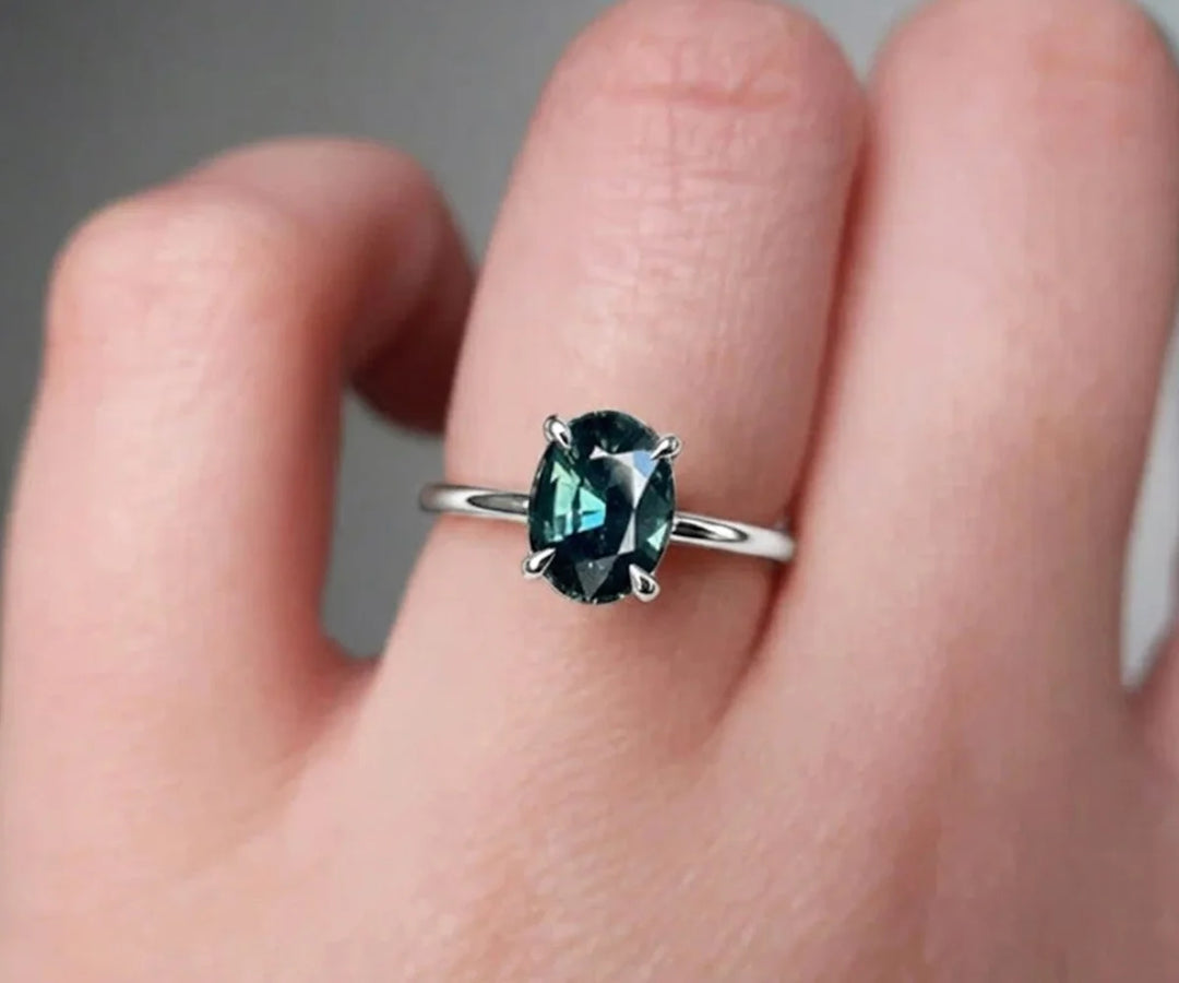 Teal sapphire engagement ring in white gold with classic prong setting and brilliant shine