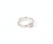 A delicate silver ring featuring a soft pink rose quartz gemstone
