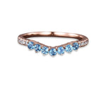 Dainty blue topaz engagement and wedding ring with a delicate setting
