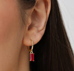 Pink sapphire hoop earrings featuring vibrant pink gemstones set in elegant hoops for a chic, feminine sparkle.
