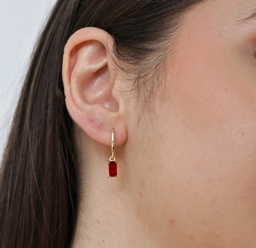 Elegant gold hoop earrings with dangling rectangular the red mirage gemstone, plated in 18K yellow gold over brass.