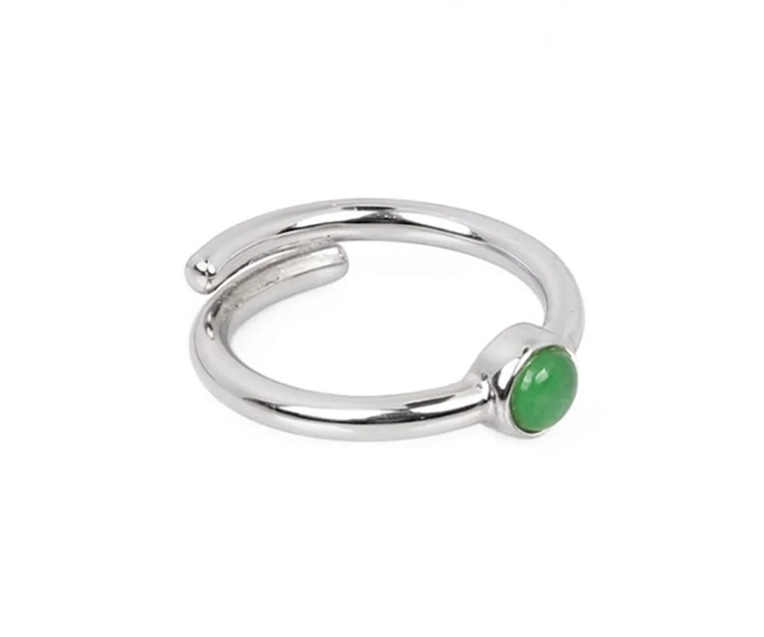 Natural green aventurine gemstone ring symbolizing luck and prosperity with a smooth glossy finish