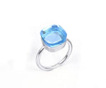 Elegant blue topaz ring with sparkling gemstone set in a sleek silver band
