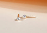 Women’s pearl stud earrings featuring classic round pearls set on delicate posts, offering a timeless and elegant accessory for any outfit.

