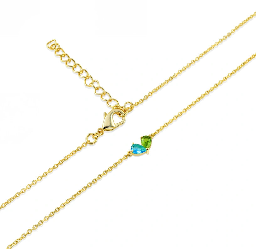 Ocean topaz necklace with adjustable chain featuring a shimmering blue topaz gemstone suspended on a versatile-length chain for elegant, seaside-inspired style.