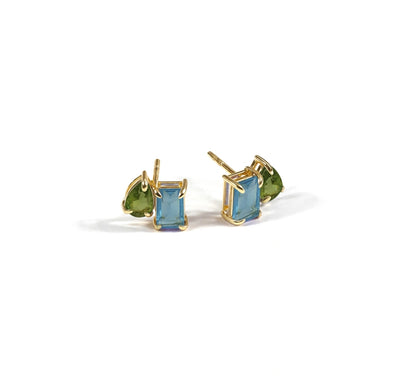 Peridot and blue topaz gemstones showcased together in a vibrant jewelry design, highlighting fresh green and sparkling blue tones.