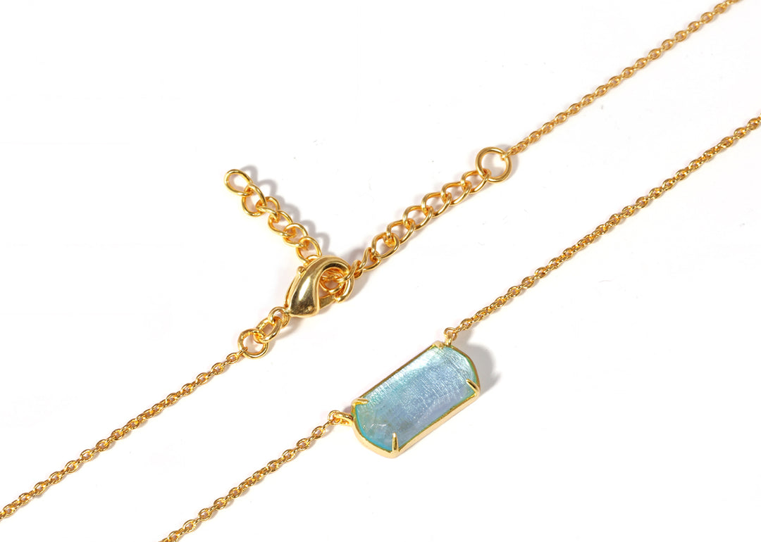 Ocean-inspired necklace displayed on neutral background