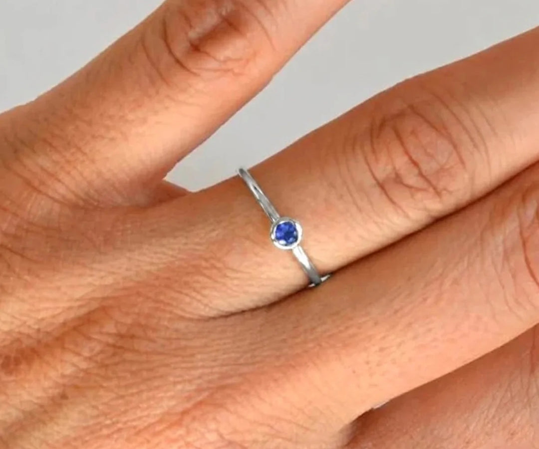 Royal blue sapphire engagement ring inspired by classic princess style with diamond accents